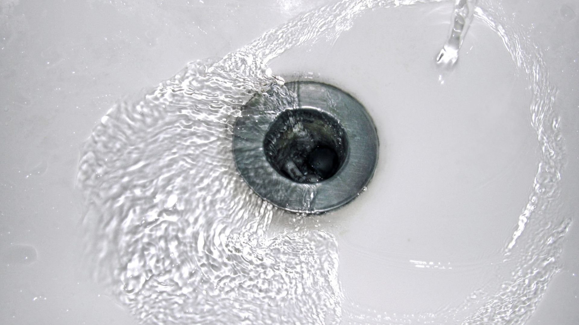 Close-up of a human eye with water droplets and rippling texture